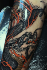 Seb's forearm dragon tattoo.